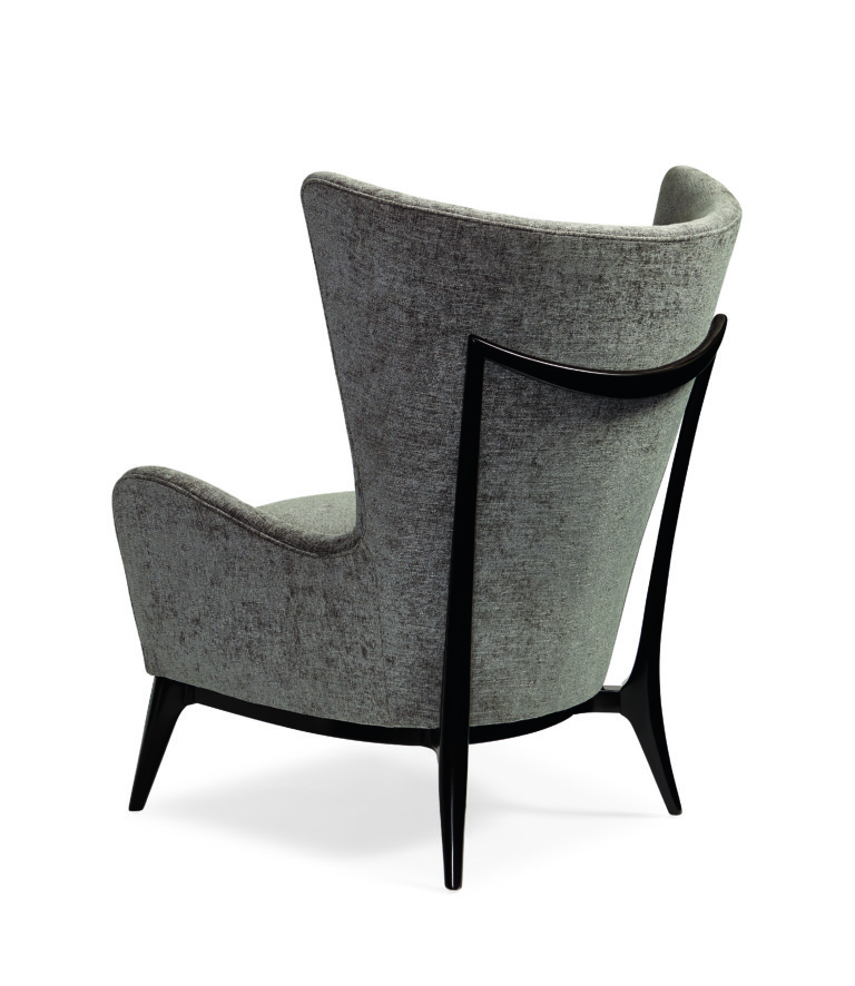 *AVAILABLE IN CARACOLE COUTURE CUSTOM UPHOLSTERY PROGRAM* This unique wing chair truly embodies Scandinavian style with the element of the wood detail across the outback finished in Almost Black. Its gracefully sloped arms and soft round back embrace you for cozy comfort in style