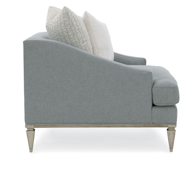 Set the scene with this luxurious chair featuring a low back and sloping arms. Upholstered in a neutral granite grey